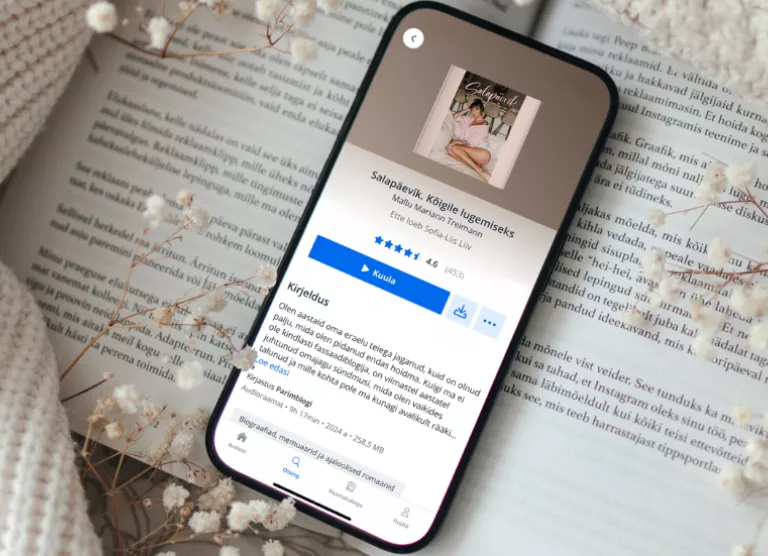 telefon laual, elisa raamatu äpp avatud